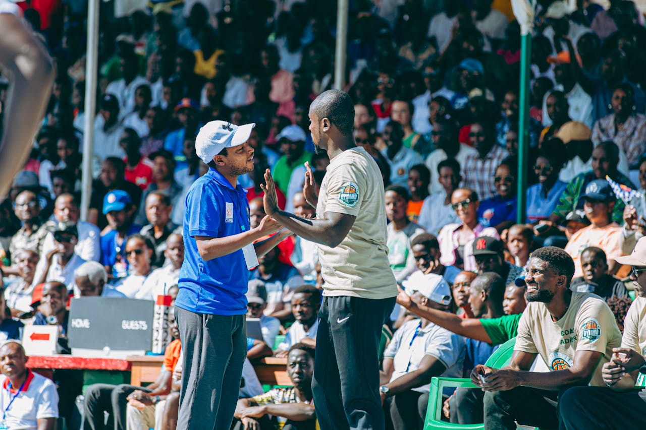 Exciting crowd at a sports event with engaging interactions among attendees.